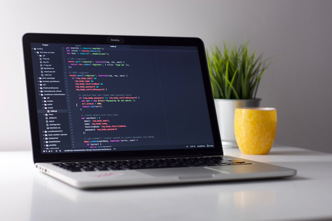 Developer workspace with laptop and code